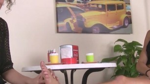 Barefoot lesbians playing hot footsies under the table