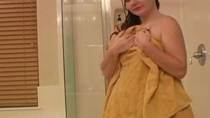 Brunette showers and fingers her tight pussy